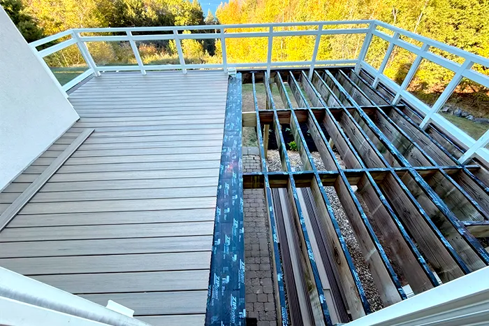 Deck framing with a waterproofing membrane installed before the decking boards go down