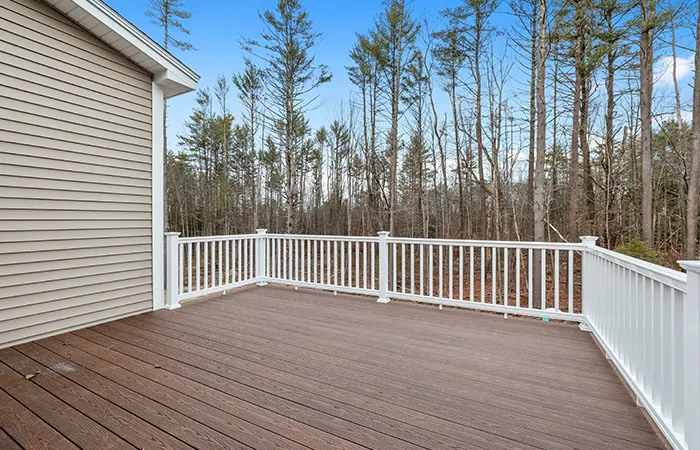 Newly built wood deck with railing and evenly spaced deck boards