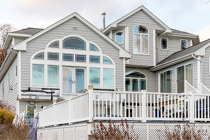 gray-shingle-siding-exterior-remodel-arched-window.webp