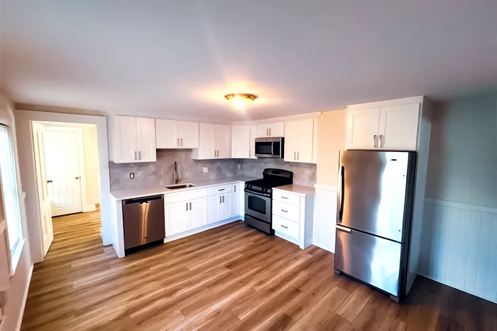 kitchen-remodel-white-shaker-cabinets-stainless-appliances.webp