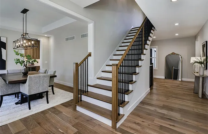Refinished staircase with a newly installed wood handrail and balusters